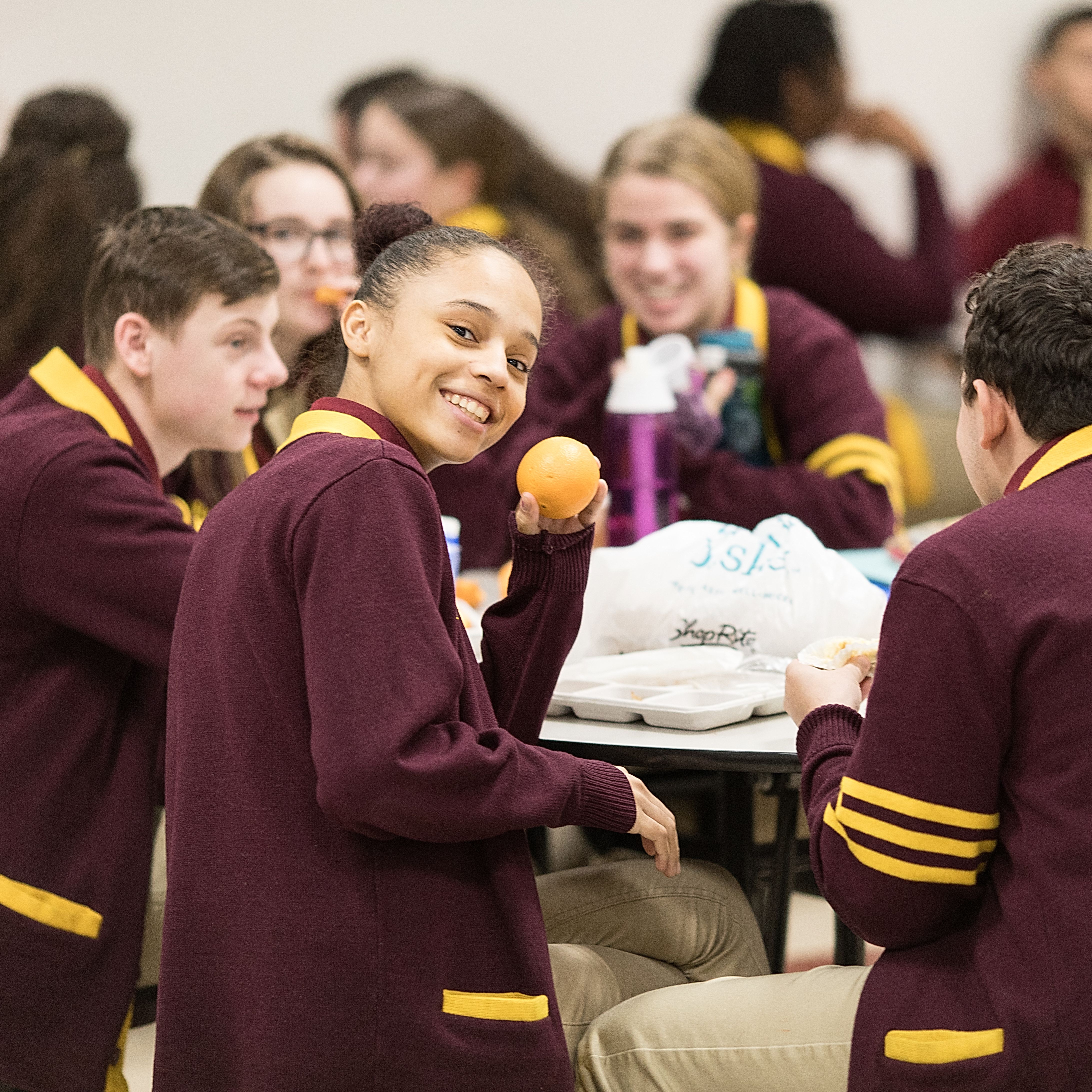  Group of senior students smiling during school lunch 